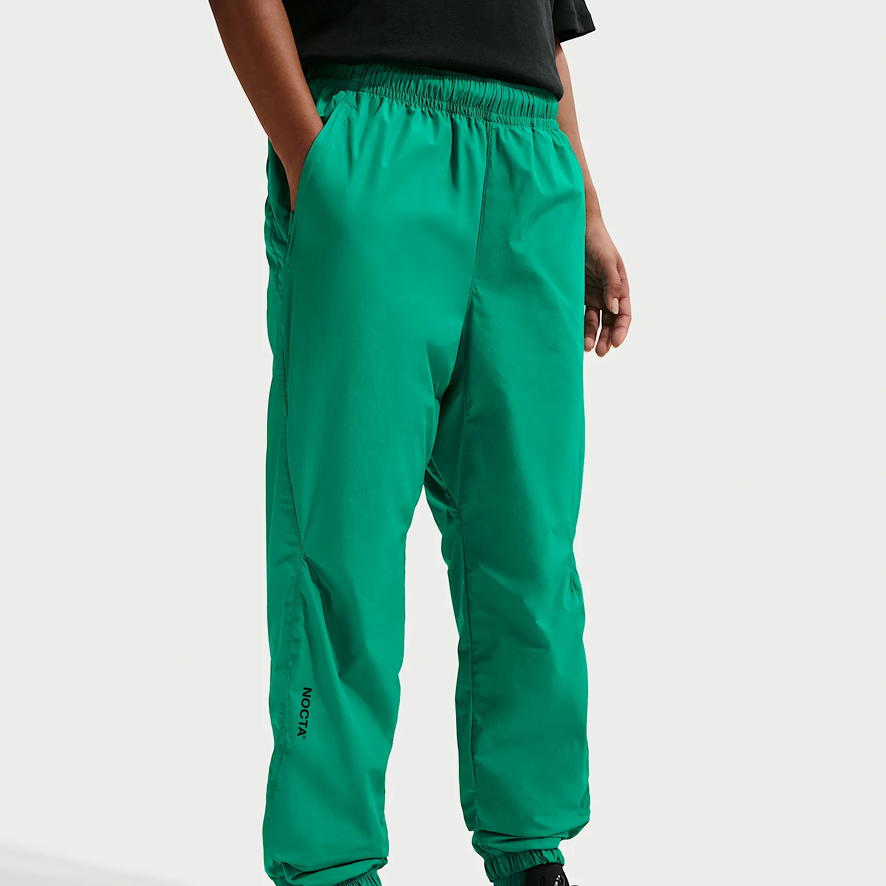 1FB491_Nocta-x-Nike-Nylon-Track-Pant_NEPTUNE-GREEN-BLACK_FN7668-340_img1