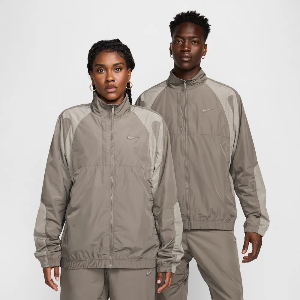 867669_NOCTA-x-Nike-Woven-Tracksuit-Jacket_BROWN-GREY_FN7666-040_img0