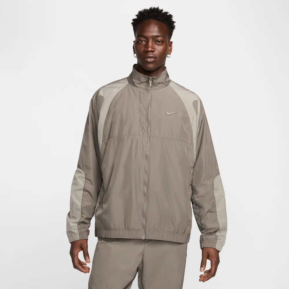 867669_NOCTA-x-Nike-Woven-Tracksuit-Jacket_BROWN-GREY_FN7666-040_img1