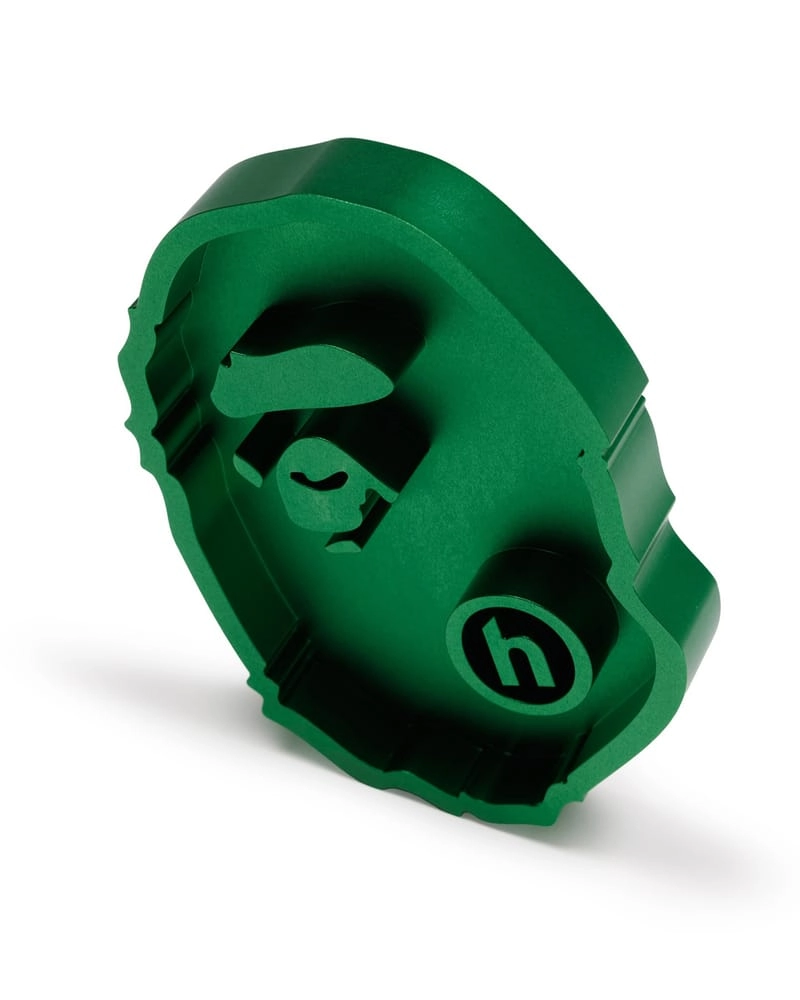 Green ashtray in the shape of an ape head with Hidden NY's h logo