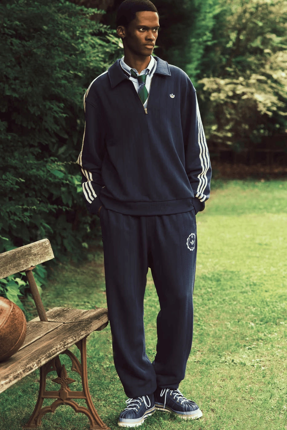 CLOT x adidas navy blue set worn by a model in a garden