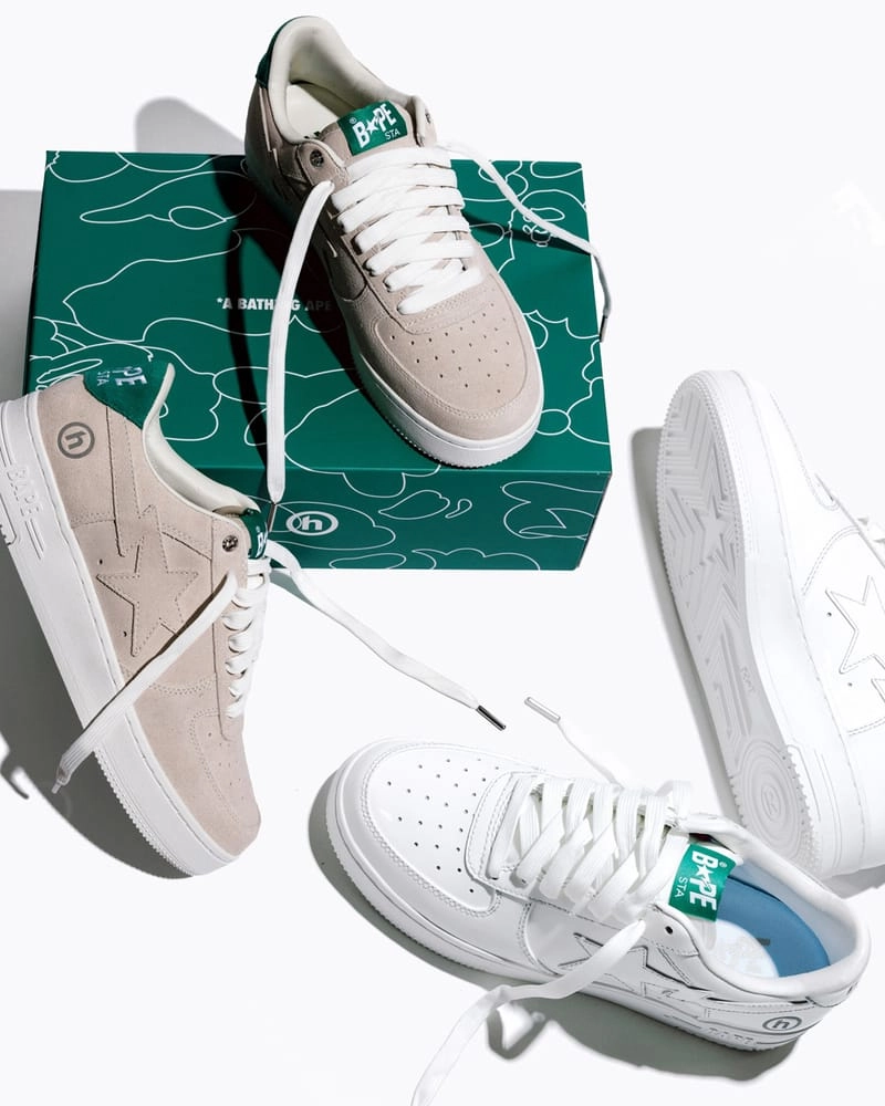 Three BAPE STA Hidden NY in smooth white leather and beige suede placed on a green BAPE box