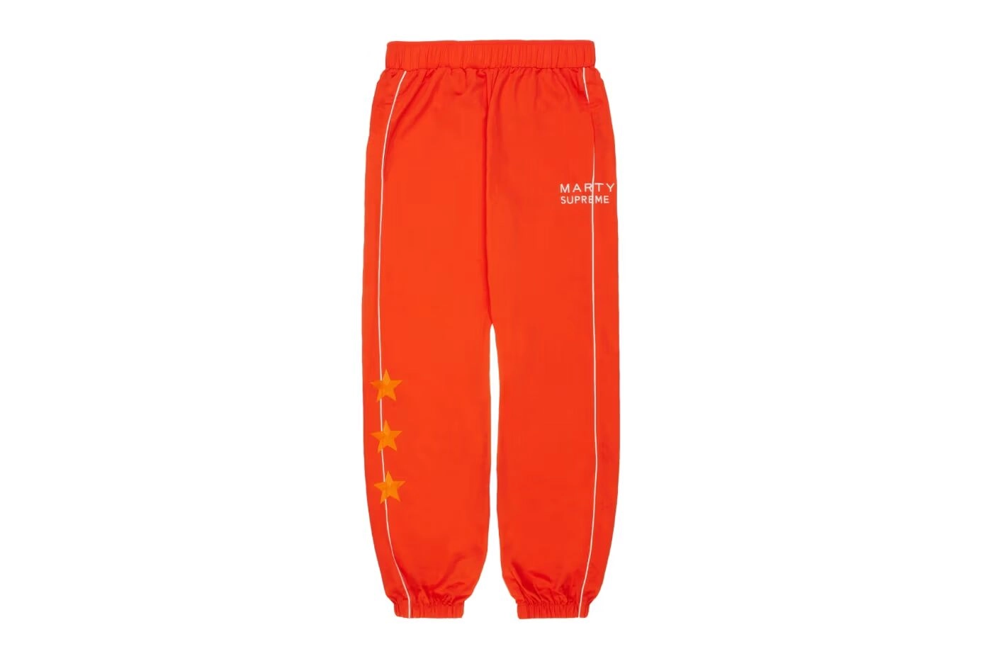 Orange Nahmias x Supreme pants with yellow stars on a white background