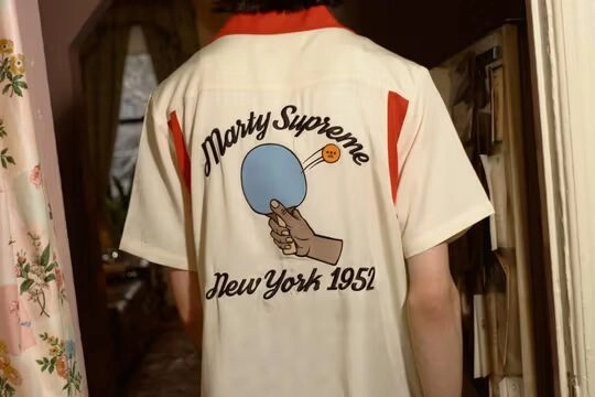 Golf Wang's Marty Supreme Collection homme portant polo veste beige de dos