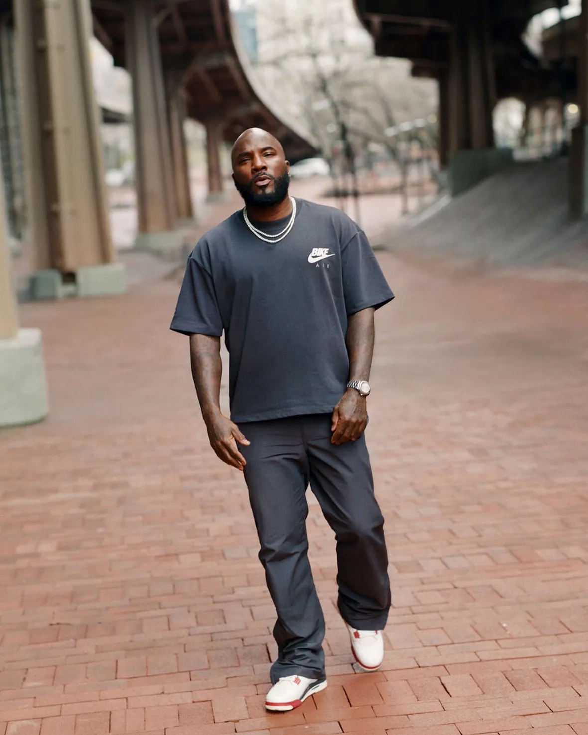 Jeezy walking wearing the Air Jordan 4 Sail Cinnabar