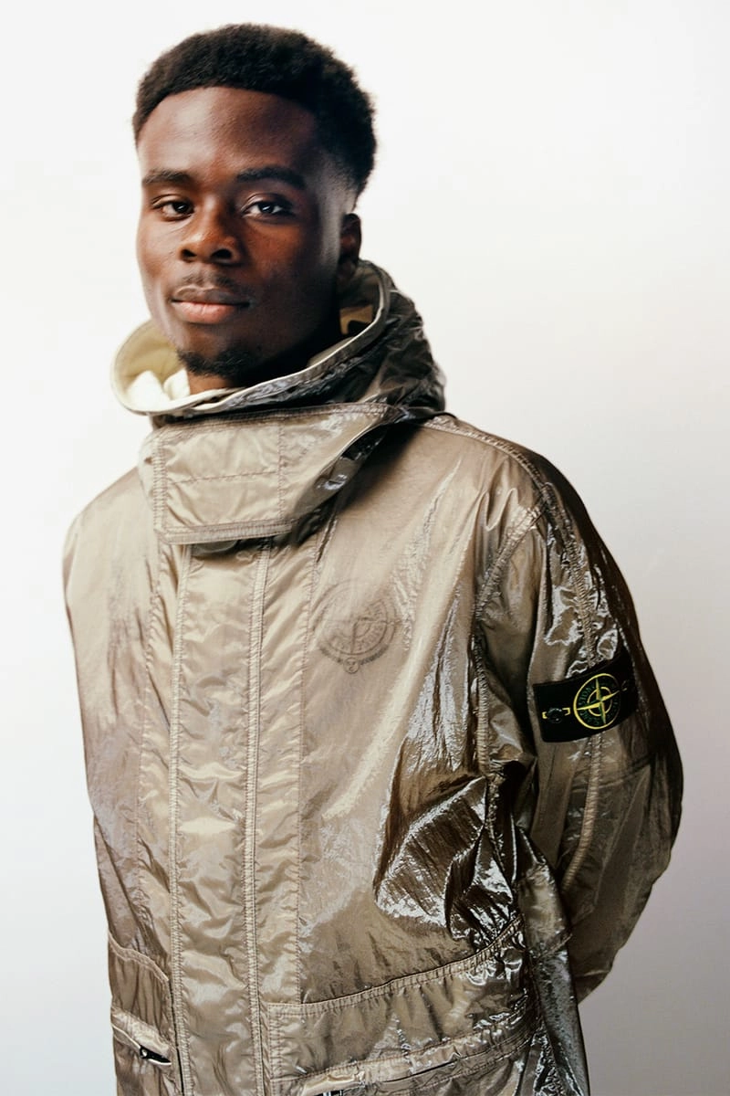 Bukayo Saka in a metallic Stone Island x New Balance jacket