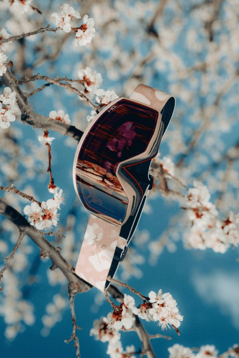 Arc'teryx Grottoflage ski mask with white flowers in the background