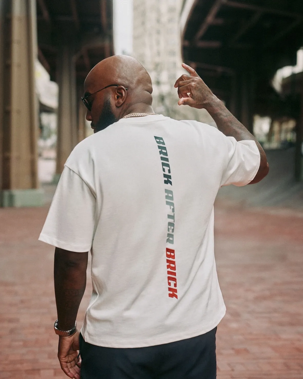 Jeezy from behind in a white Brick After Brick t-shirt