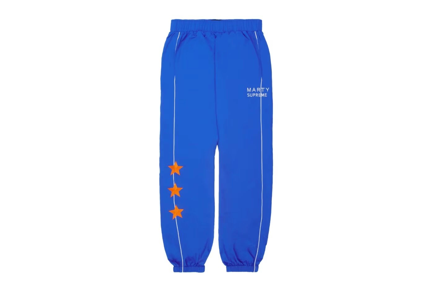 Blue Marty Supreme pants with three orange stars and text on a white background