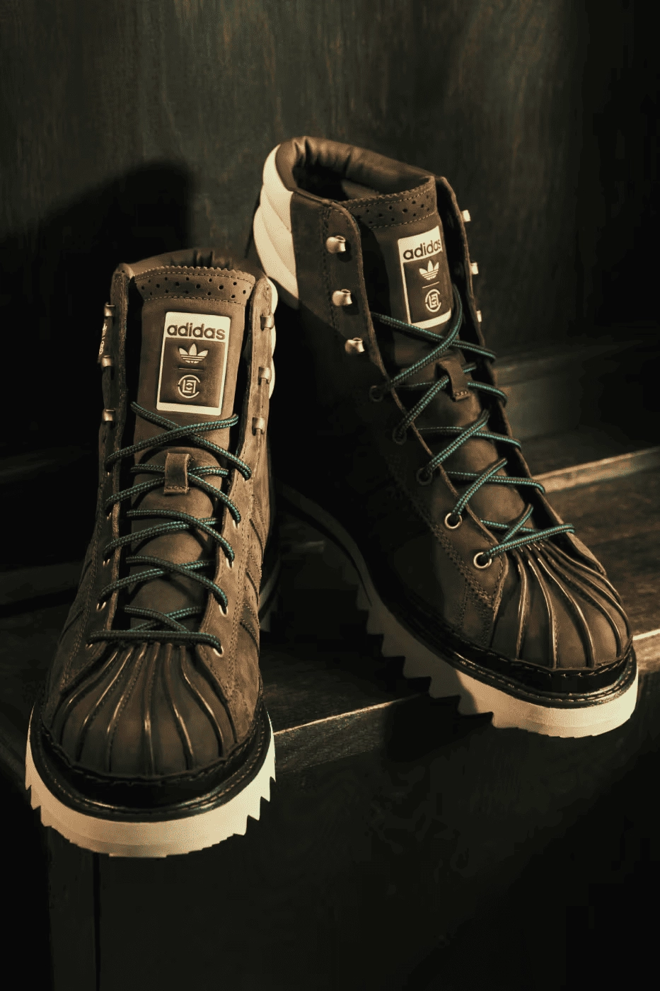 CLOT adidas Pro Model brown boots with white sole on wood background