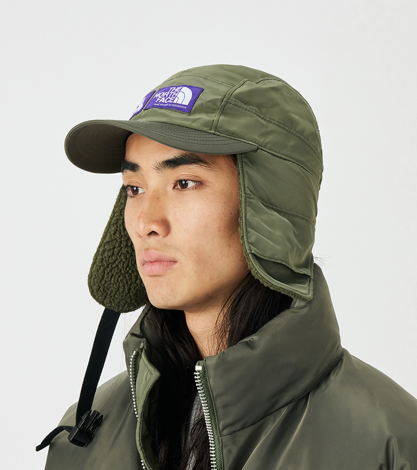 Mannequin wearing green caps The North Face Purple Label x Palace with purple logo