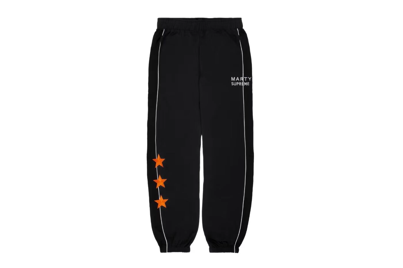 Black Nahmias Marty Supreme pants, orange stars and white details