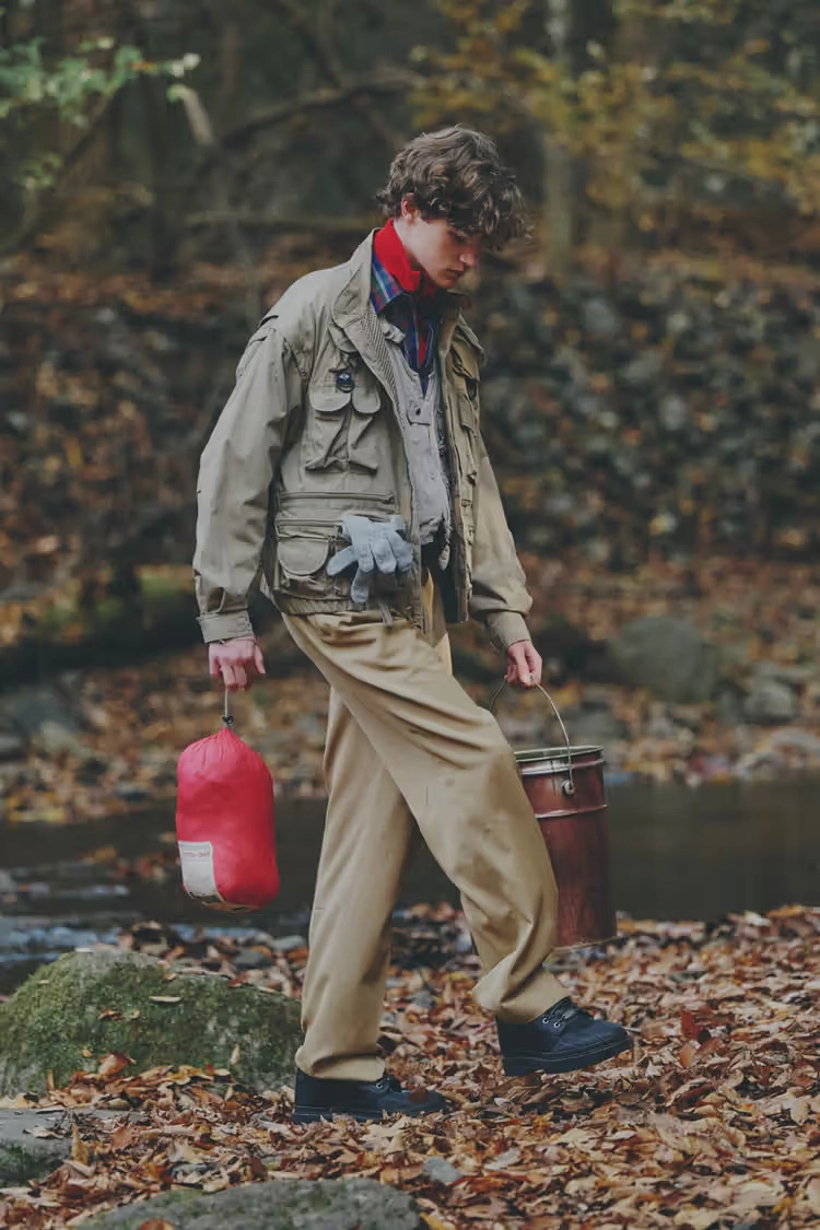 person wearing Converse 1908 Bronco boots walking on autumn leaves