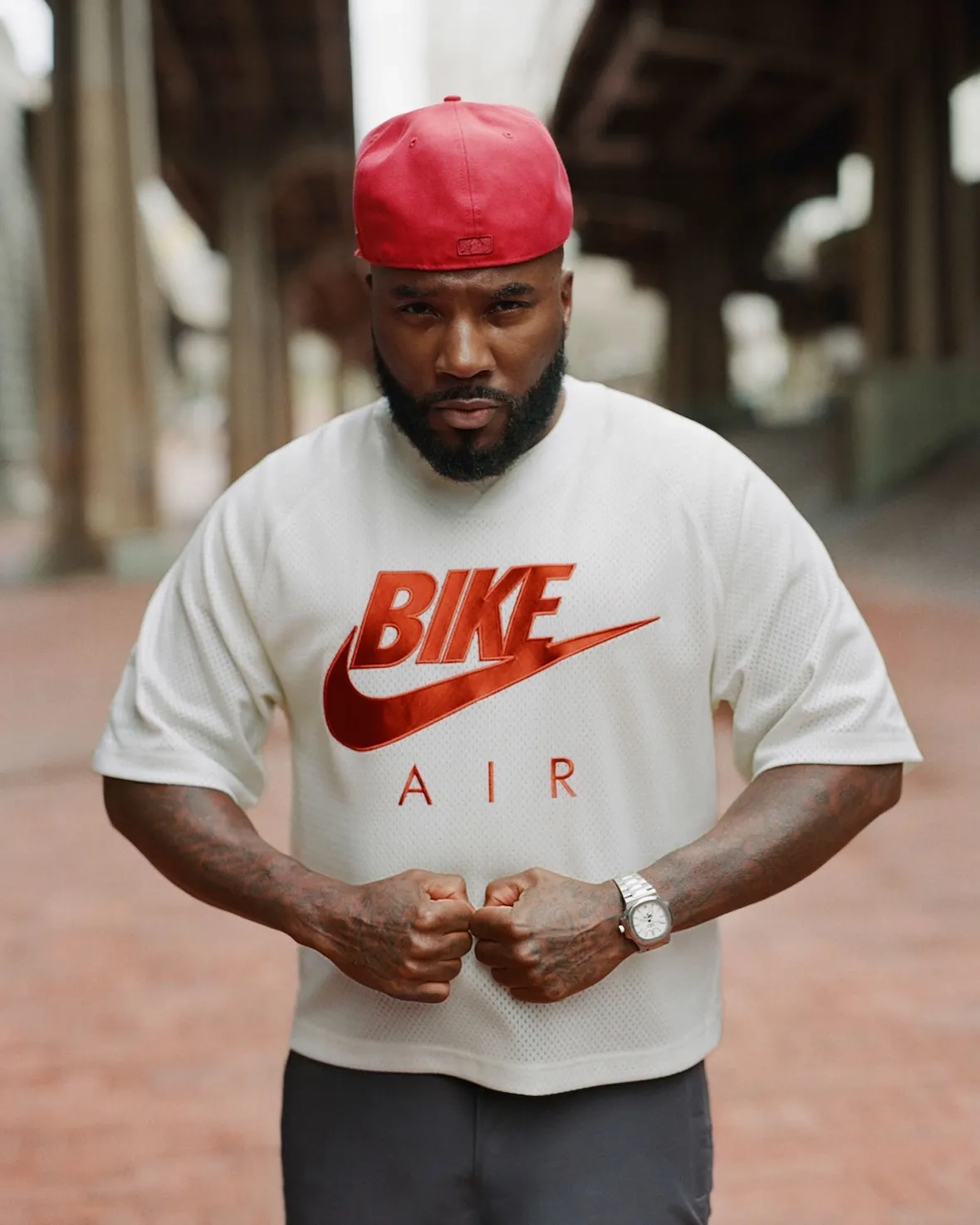 Portrait of Jeezy in a white Bike Air t-shirt and red cap