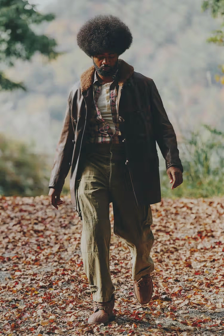person wearing brown Converse 1908 Bronco boots walking on autumn leaves