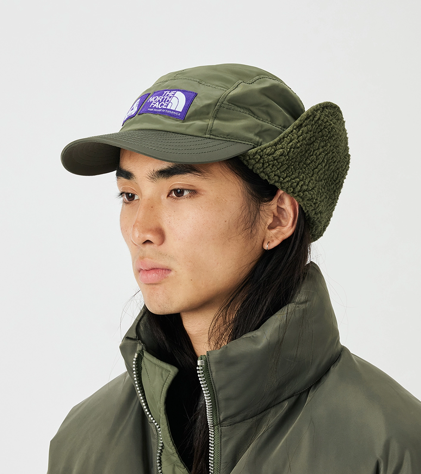 Mannequin wearing green caps The North Face Purple Label x Palace with raised purple logo